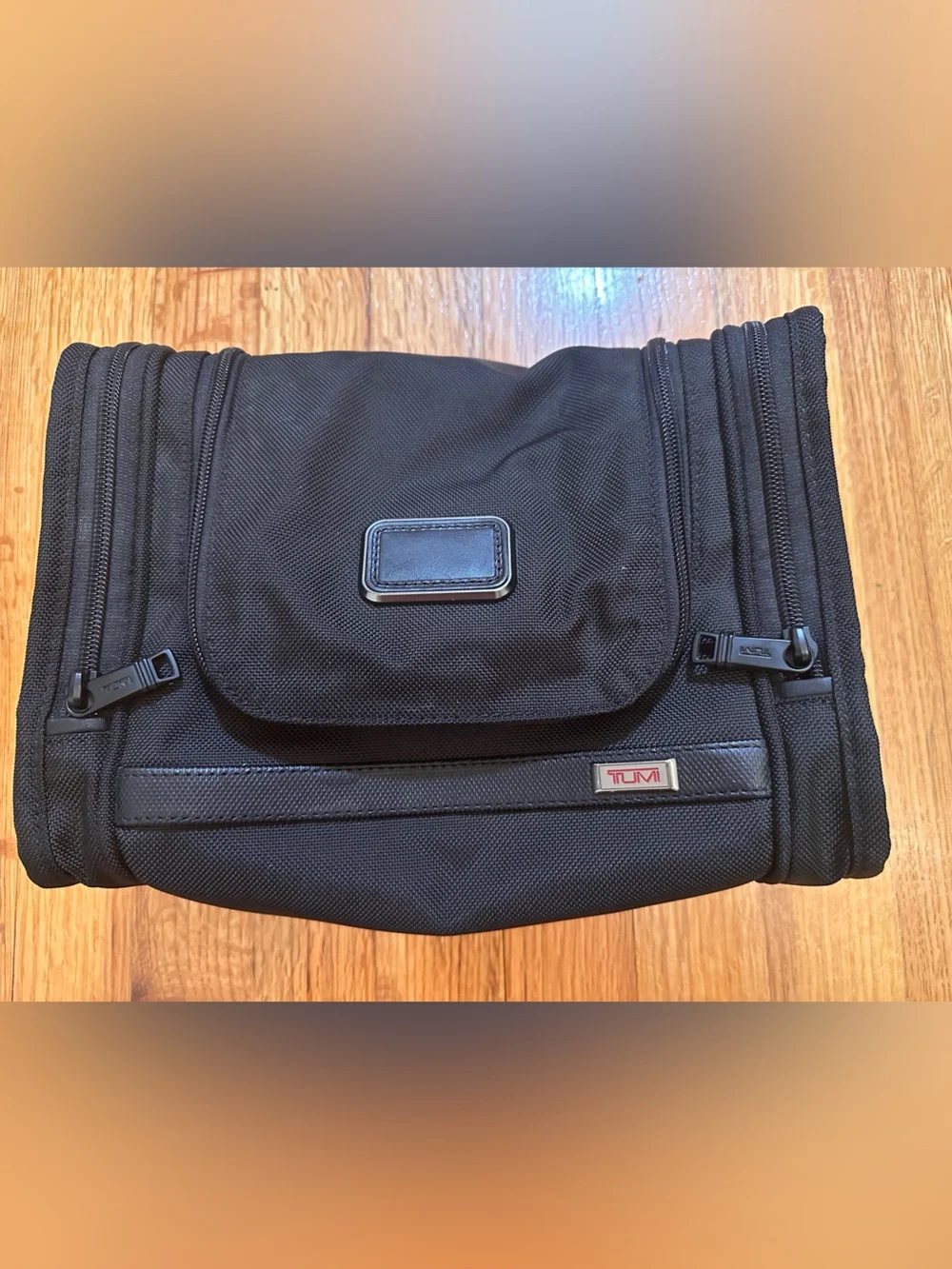 Tumi hanging travel kit with hook for hanging.